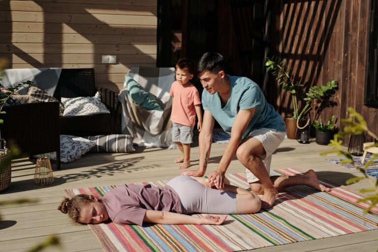 Physiotherapist working with young child with cerebral palsy on floor exercise
